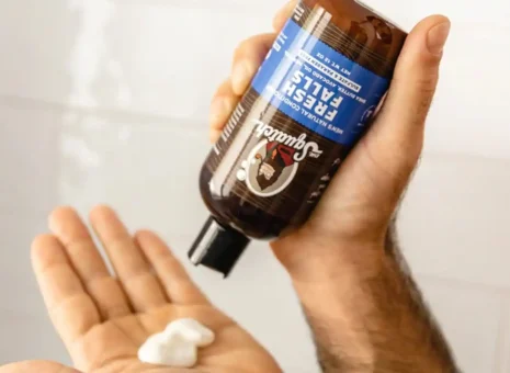 A person using a Dr. Squatch grooming product received through HLS