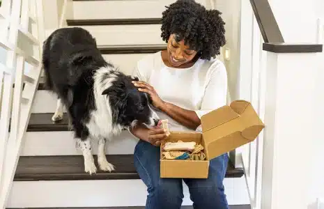 Woman opening a subscription box received from HLS